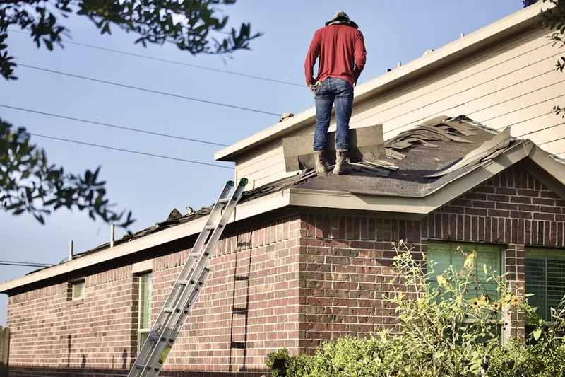 Professional roofer working on a residential roof in Montclair Lake Estates